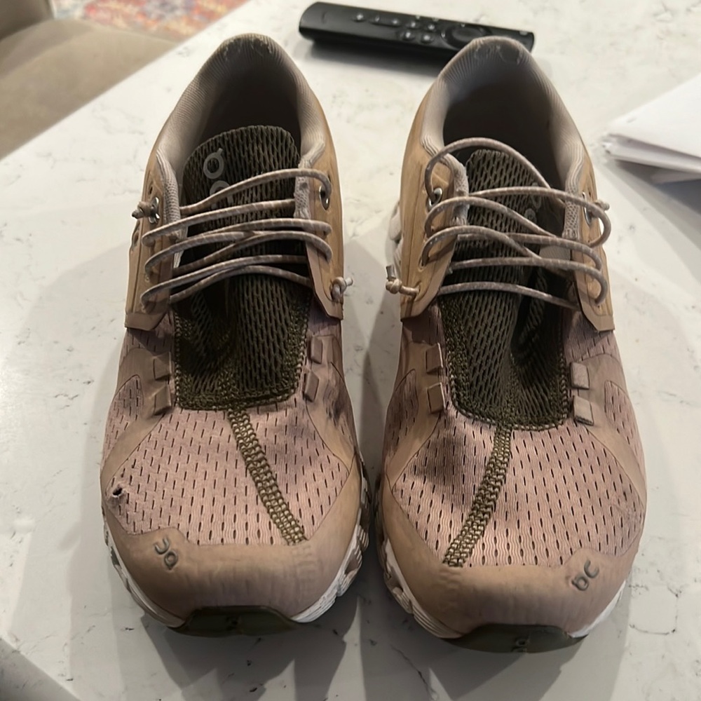 On cloud tennis shoes. Worn for work. Small pen size hole. See picture.